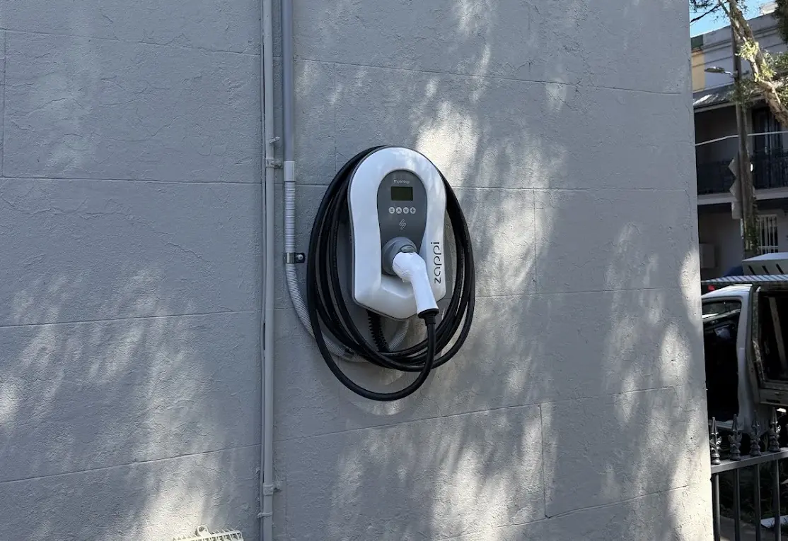 Zappi EV charger installed by Gemelec on the side wall of a home